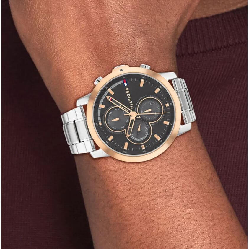 TOMMY HILFIGER Mod. 1792050 men's quartz watch with stainless steel bracelet and black dial, worn on wrist, 5 ATM water resistant.