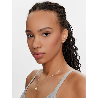 Woman wearing SWAROVSKI Mod. 5689624 earrings, silver 925°, quartz analog movement, mineral dial, 38mm case, water resistant 5 ATM.