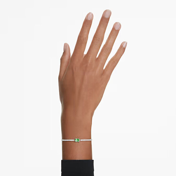 Elegant hand wearing SWAROVSKI Mod. 5693411 earrings with silver 925°, quartz analog movement, water resistant 5 ATM.