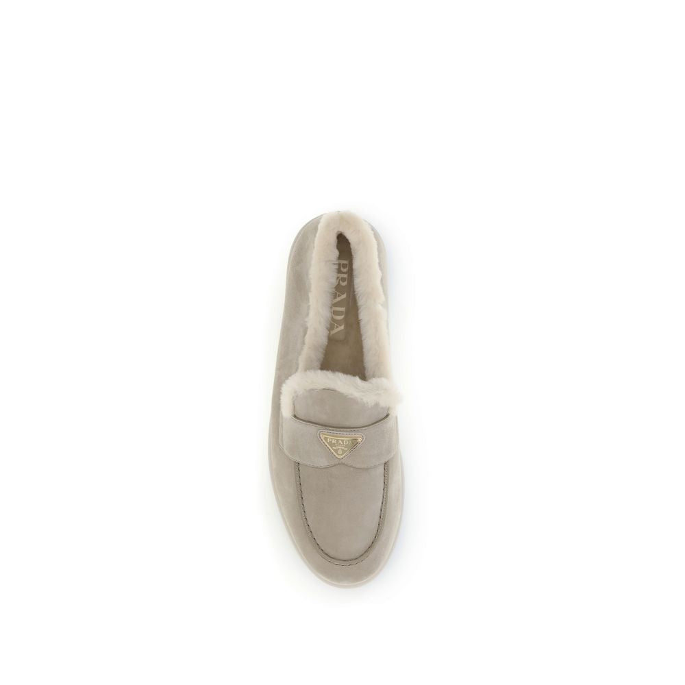 Prada Suede Loafers with round toe, fur lining, and logo plaque on top view, made in Italy, AW25 collection, luxury footwear.