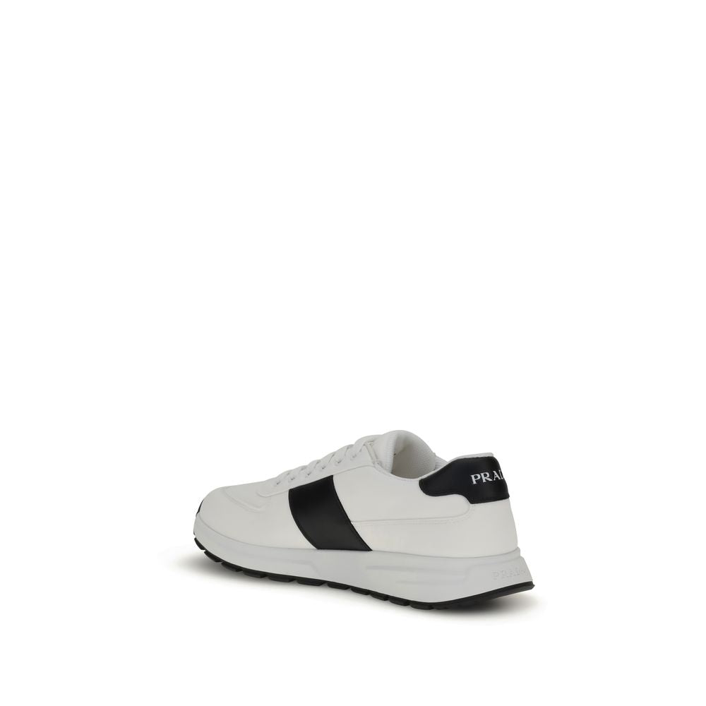 Prada Leather Sneakers in two-tone design with logo detail, lace-up closure, and rubber sole, showcasing elegance and contemporary style.