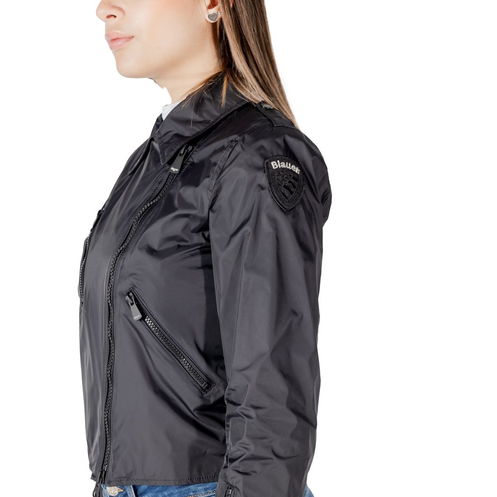 Side view of a woman wearing a Blauer Black Polyamide Biker Jacket with zip closure and side pockets, ideal for spring and autumn fashion.