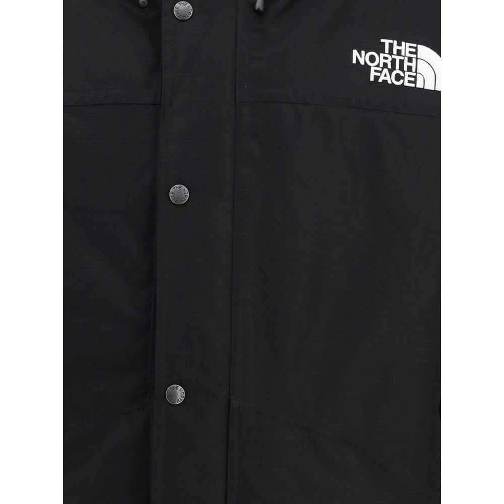 The North Face Black Polyester Coat featuring front buttons and logo displayed, ideal for harsh weather protection and comfort.