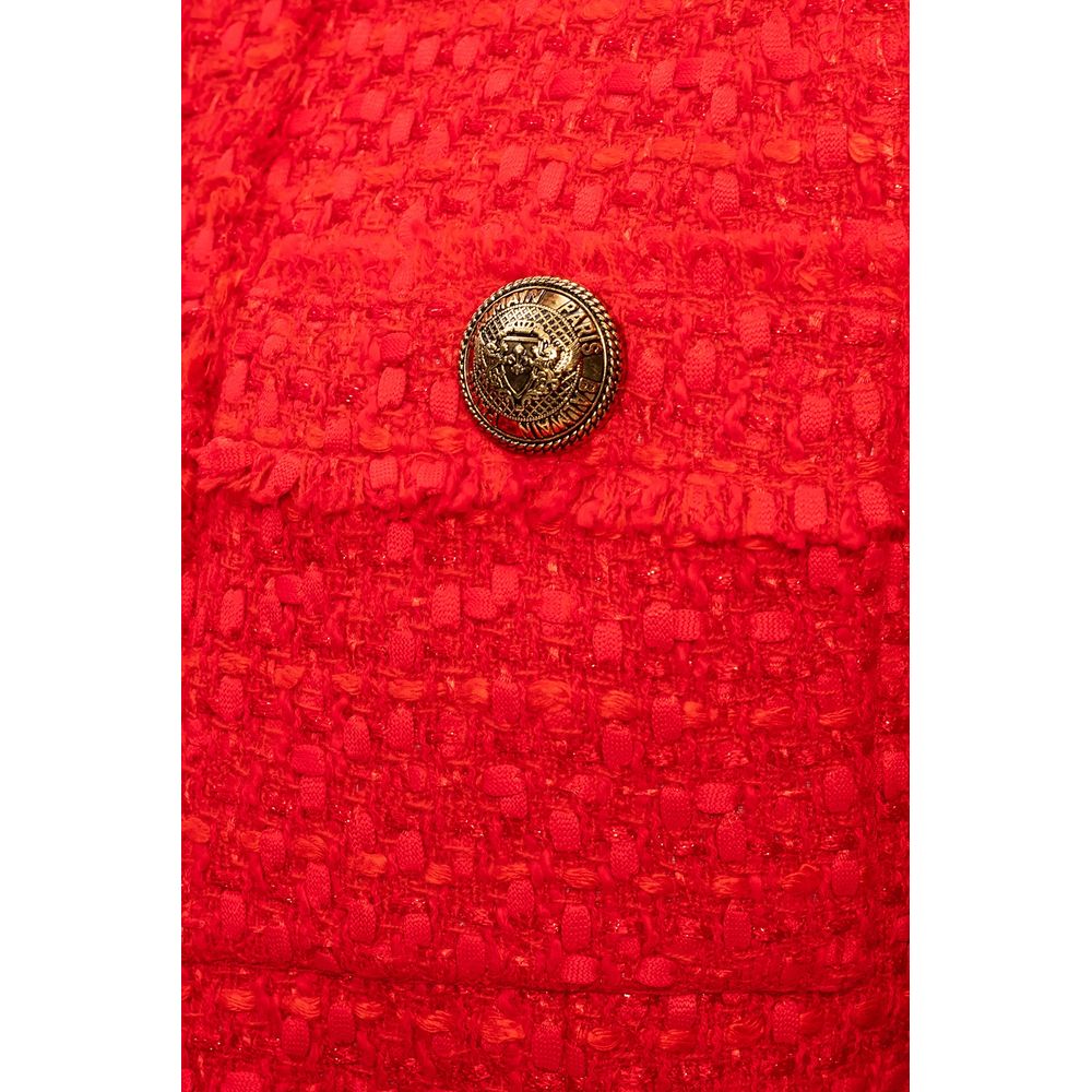 Close-up of Balmain Red Nylon Suits & Blazer showcasing gold button on wool-viscose blend with raw-cut detail.