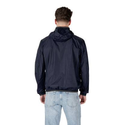 Back view of a man wearing a Blauer Blue Polyamide Shell Jacket, showcasing the sporty design and lightweight material.