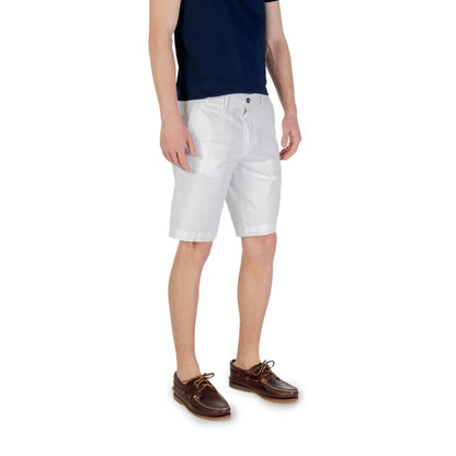 Model wearing Borghese White Cotton Bermuda Shorts paired with a navy t-shirt and brown boat shoes, showcasing summer casual style.