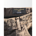 Close-up of Dolce & Gabbana Beige Black Corduroy Tie-Dye Cotton Blend Pants showing label and tie-dye texture.