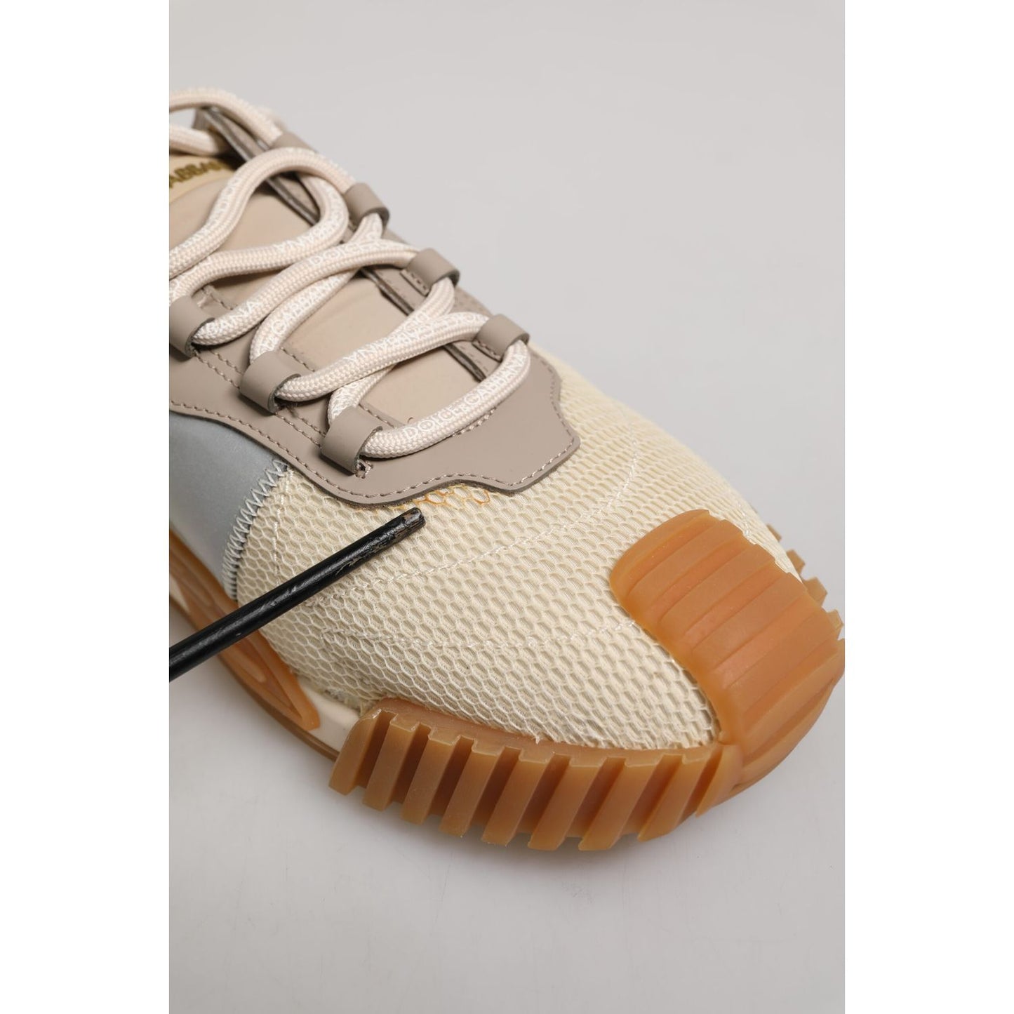 Close-up of Dolce & Gabbana Beige Lace Up Low Top NS1 Men Sneakers Shoes showing rubber sole and glue mark defect.