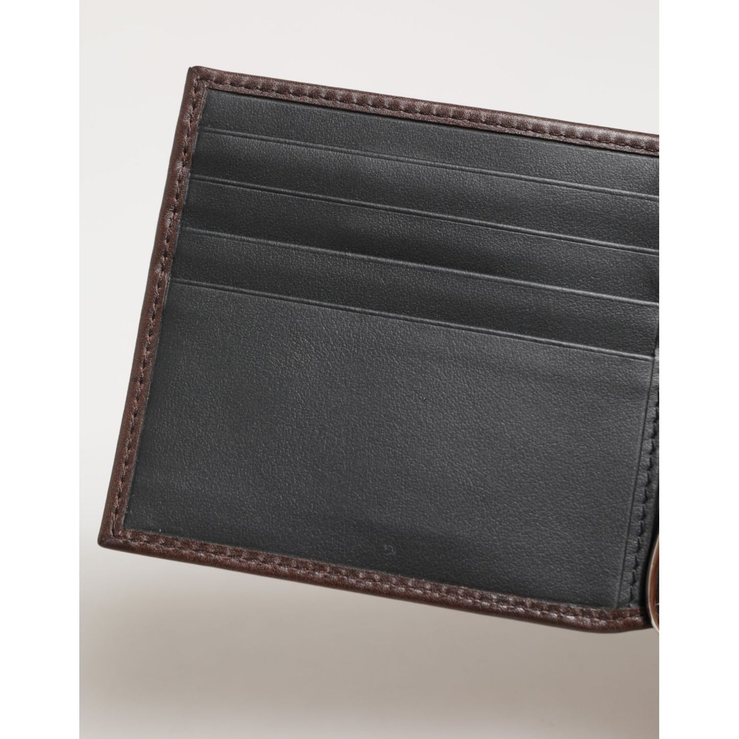 Open view of Dolce & Gabbana Brown Leather DG Logo Engrave Bifold Card Holder Wallet showing interior card slots.