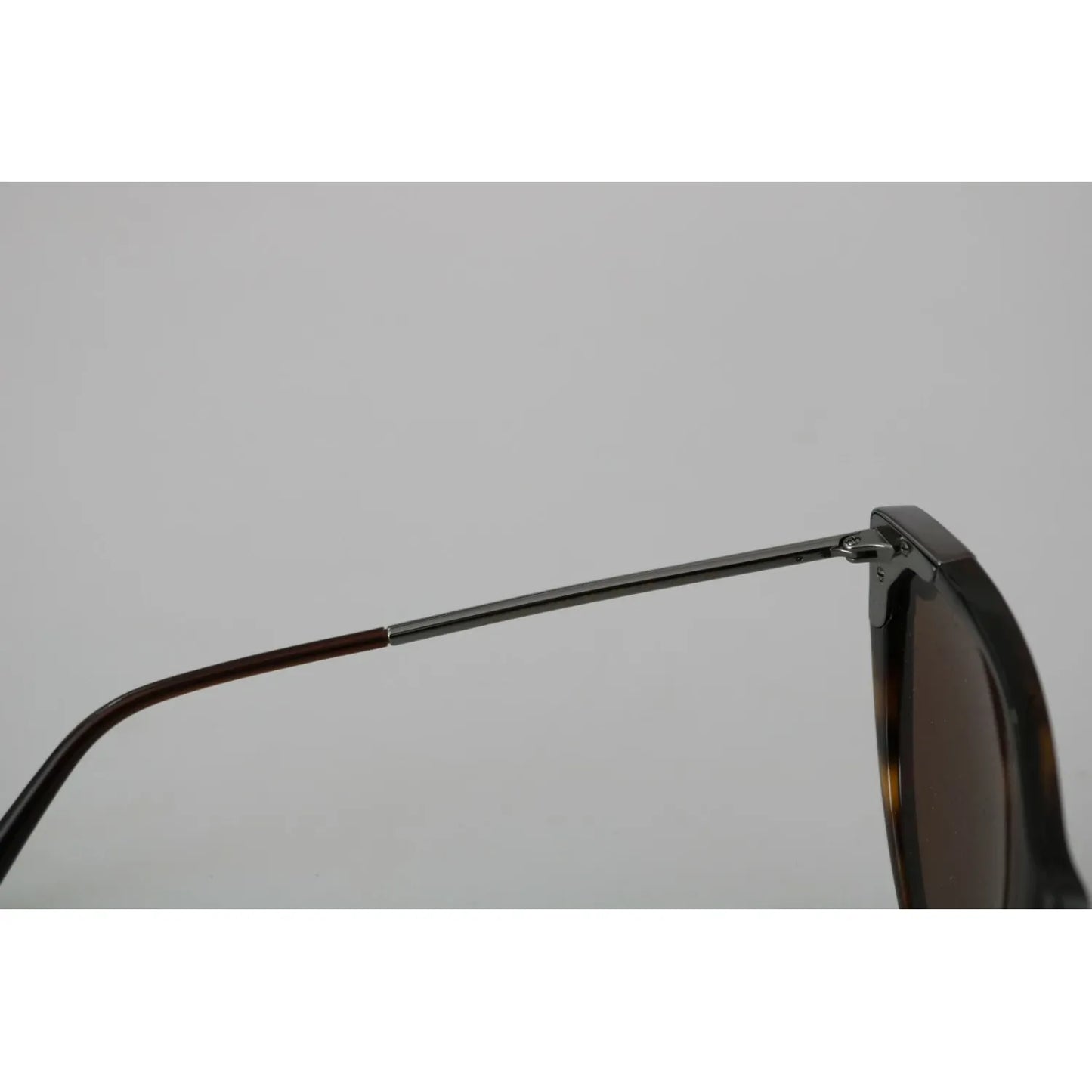 Close-up of Dolce & Gabbana DG4337 Dark Havana Cat Eye Women Eyewear Sunglasses showing missing metal stud on left side.