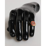 Dolce & Gabbana Gold Tone Real Brass Round Red DG Logo Men Ring displayed on black mannequin hand.