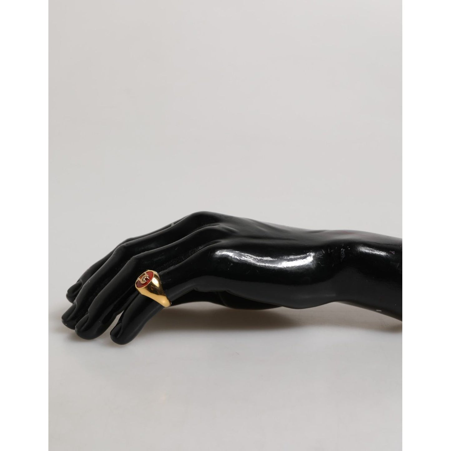 Dolce & Gabbana Gold Tone Real Brass Round Red DG Logo Men Ring displayed on black mannequin hand