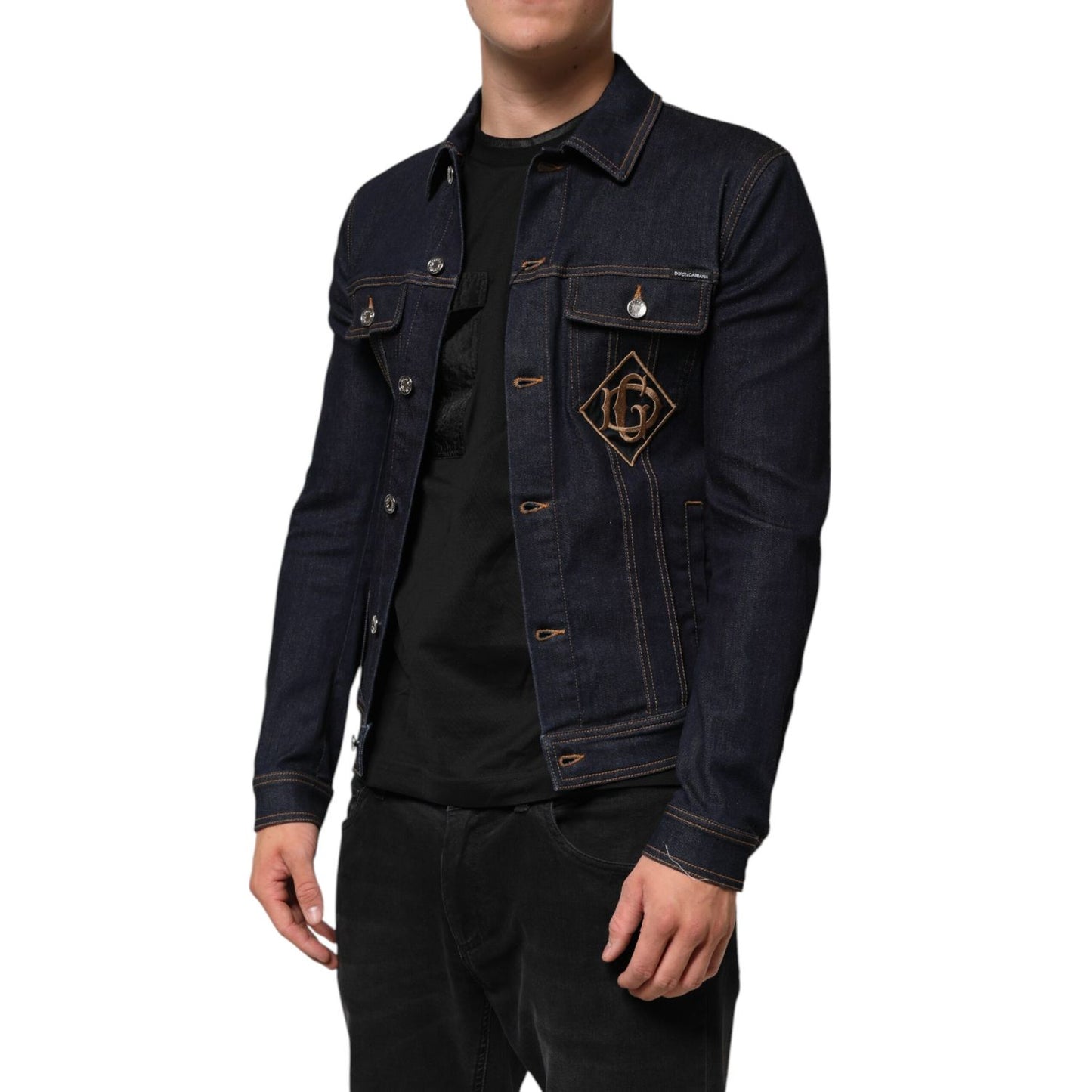 Man wearing Dolce & Gabbana Indigo Blue Denim Slim Fit Logo Patch Jacket with contrast stitching and DG logo patch embroidery.