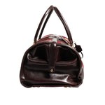 Side view of Dolce & Gabbana Multicolor Leather Jacquard Velvet Travel Duffle Bag with leather handle and metal hardware.