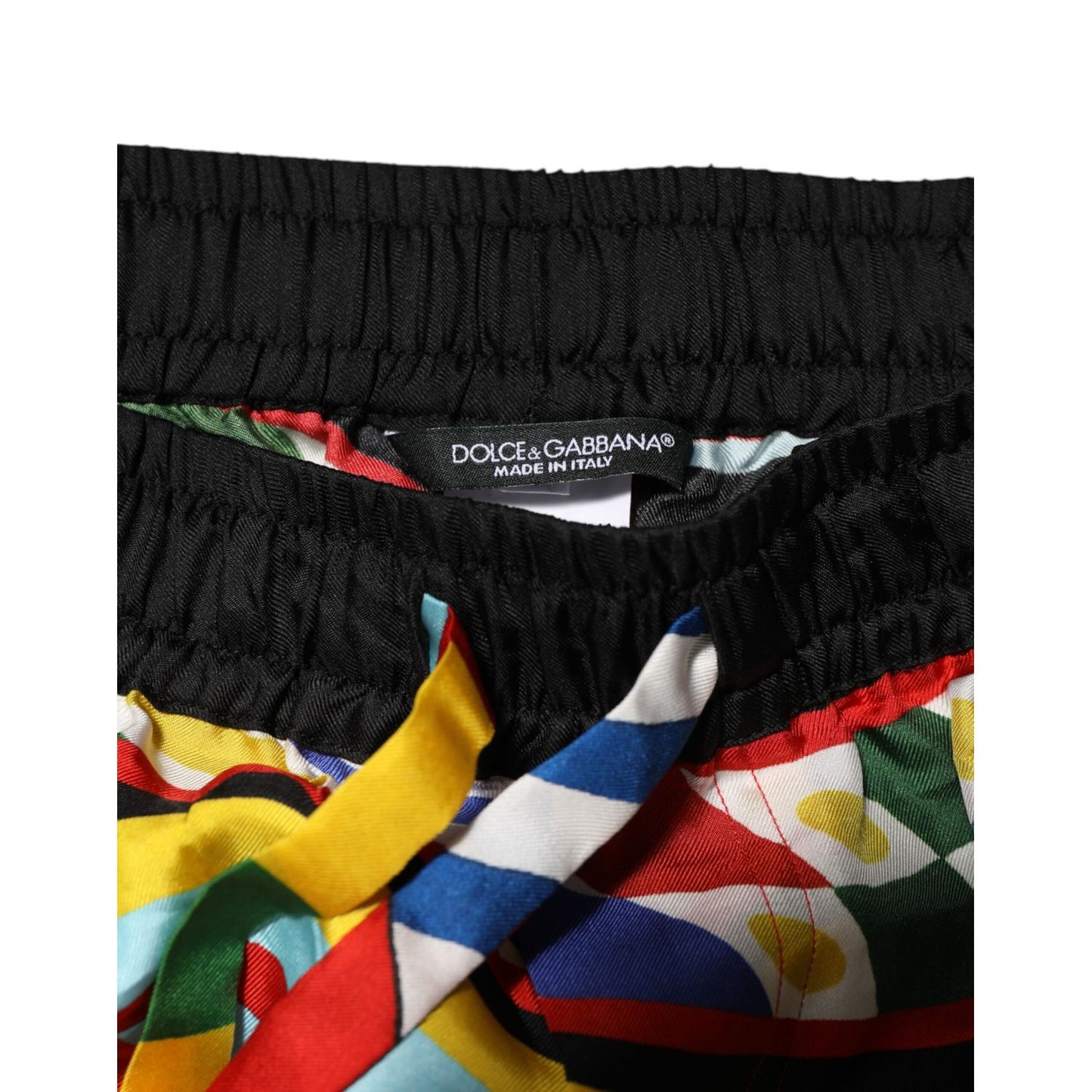 Close-up of Dolce & Gabbana Multicolor Sicilian Carretto Shorts Swimwear with vibrant silk print and drawstring detail.