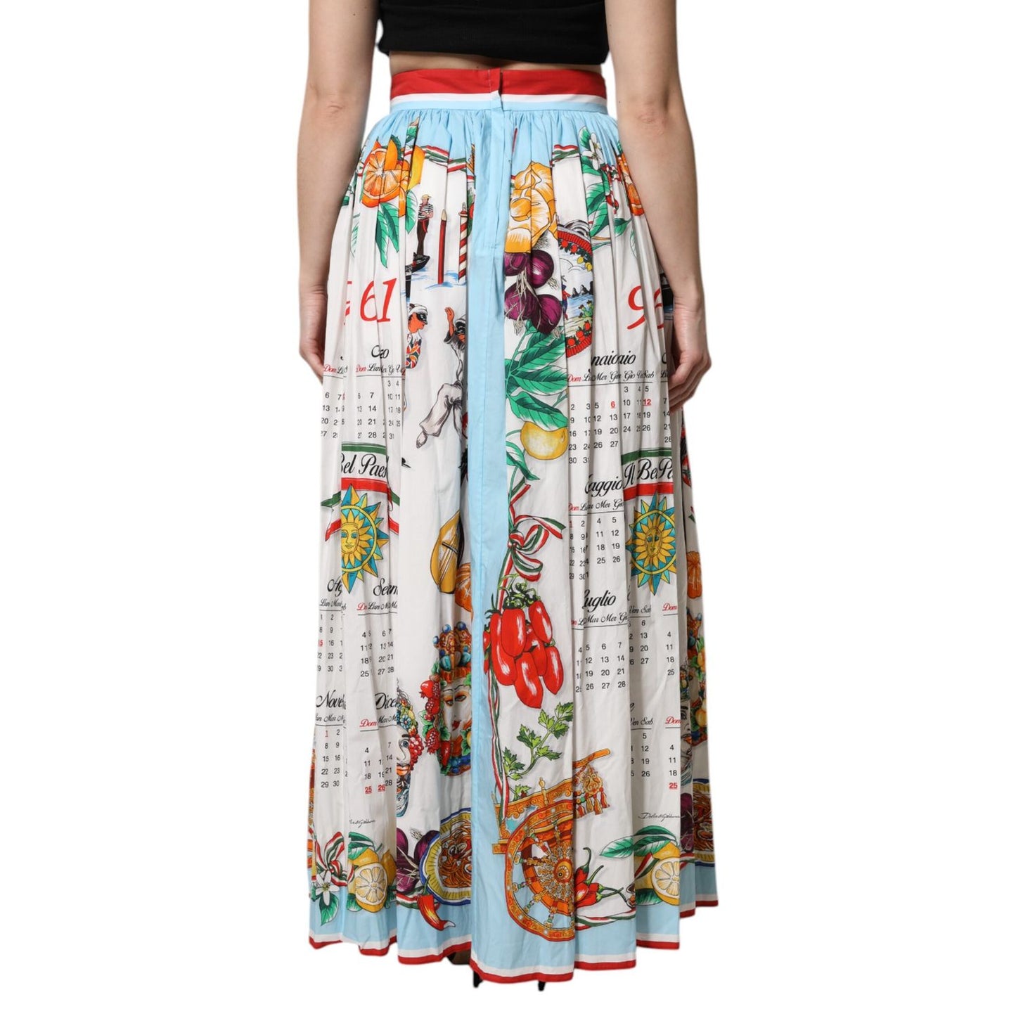 Model wearing Dolce & Gabbana White Calendar Print Cotton Gathered Maxi Skirt, showcasing a vibrant print with a gathered design.