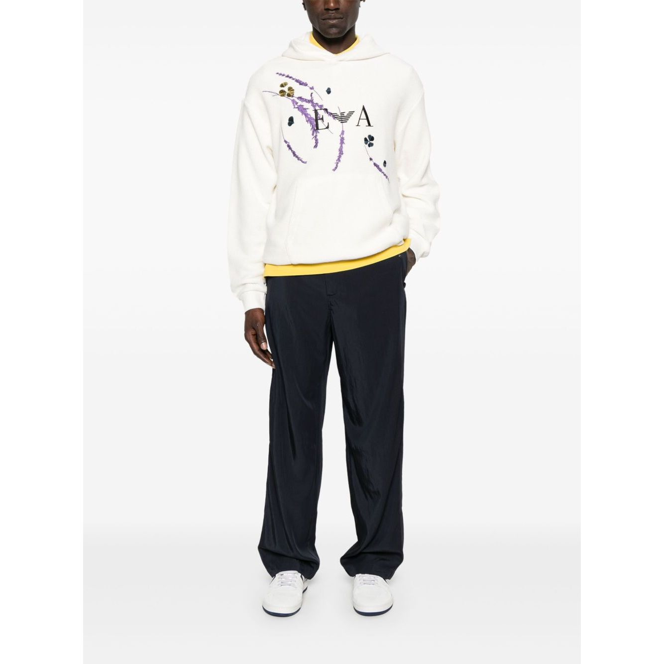 Man wearing EMPORIO ARMANI EXCLUSIVE Sweaters White, featuring a classic hood, front pouch pocket, and printed design.