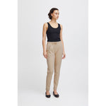 Woman wearing ICHI Beige Polyester Pant with a black top, showcasing slim fit design and elastic waistband.
