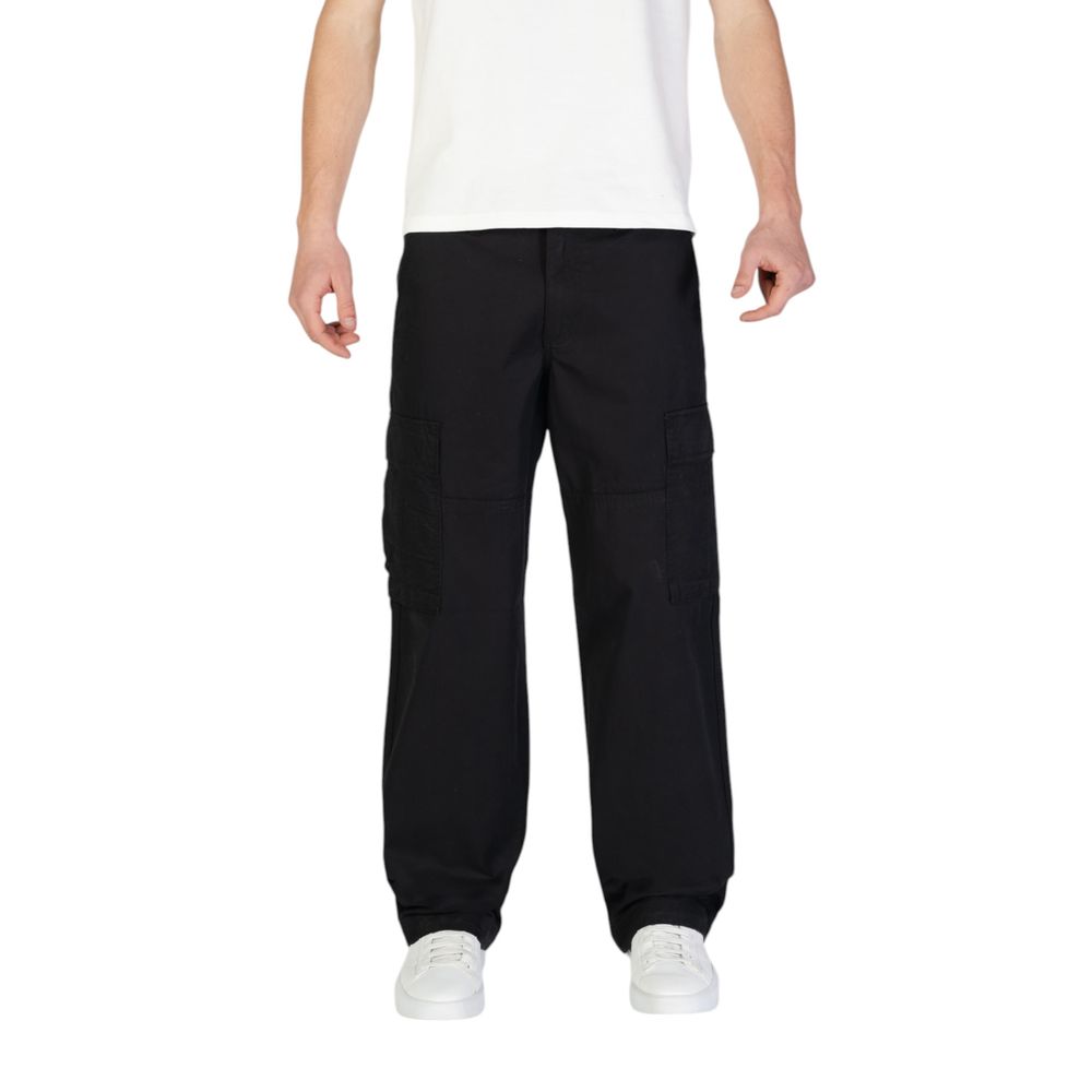 Model wearing Jack Jones Black Cotton Cargo Pants with side flap pockets and a regular fit, emphasizing comfort and style.
