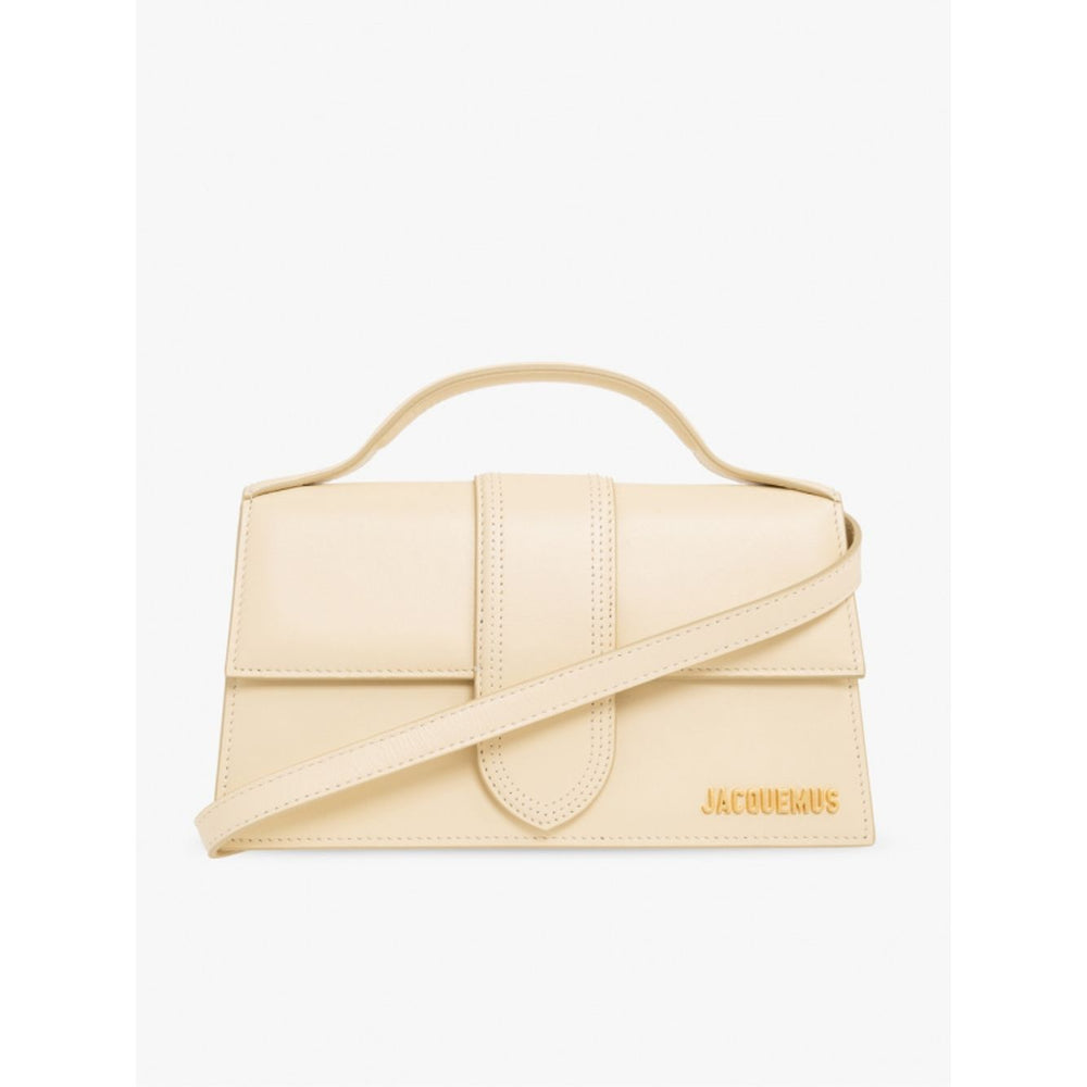 Jacquemus Le Grand Bambino Beige Bag with gold hardware, adjustable strap, and magnetic closure, featuring the Jacquemus logo.