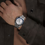Gent wearing SEIKO 5 Mod. SPORTS AUTOMATIC GMT - WHITE on wrist, featuring 42mm stainless steel case and SS bracelet.