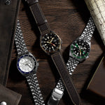 SEIKO 5 Mod. SPORTS AUTOMATIC GMT - WHITE wristwatch with stainless steel bracelet on display with other models.