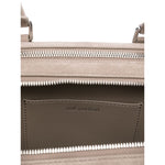Interior view of Self-Portrait suede baguette shoulder bag showing top zip and slip pocket with silver-tone hardware.