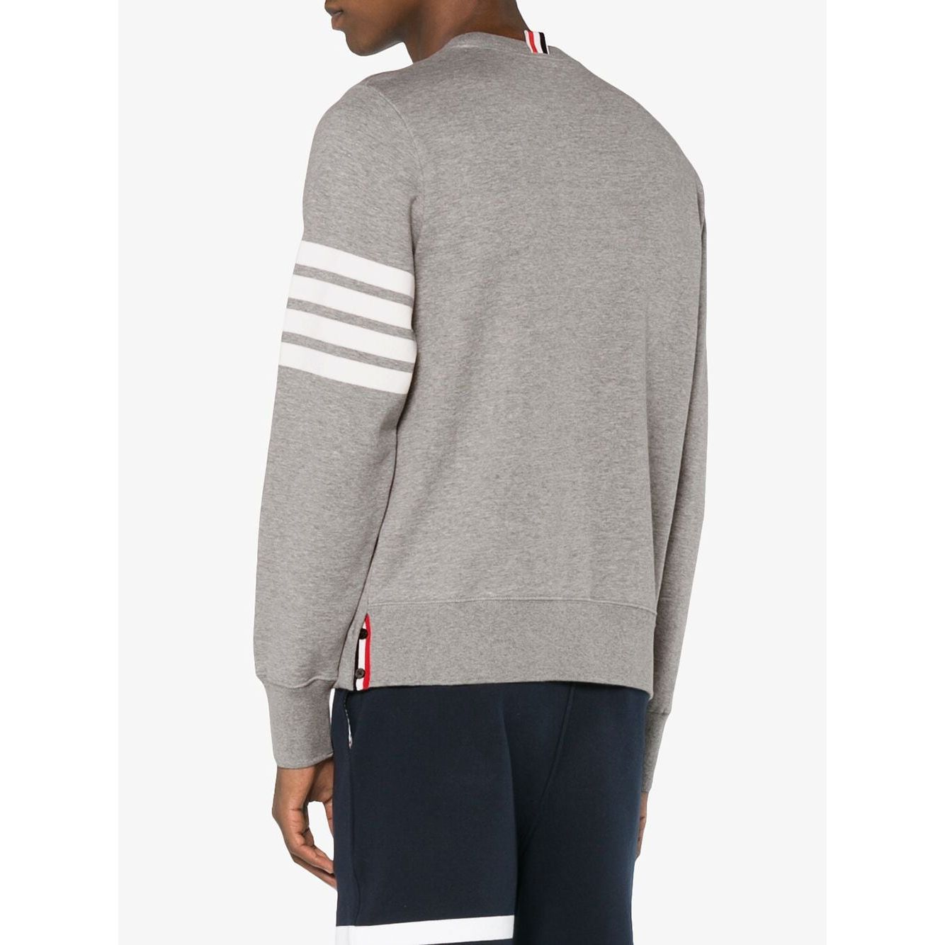 Back view of Thom Browne Sweaters Light Grey with 4-Bar stripe and tricolour grosgrain loop on model in navy pants.